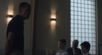 Movie still from “Boy Erased” (2018), directed by Joel Edgerton – A group of people sitting in front of a window; Medium shot, Low angle