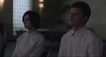 Movie still from “Boy Erased” (2018), directed by Joel Edgerton – A man and a woman are standing next to each other; Medium shot, Over the shoulder angle