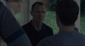 Movie still from “Boy Erased” (2018), directed by Joel Edgerton – A man standing in front of a group of people; Close Up shot, Over the shoulder angle