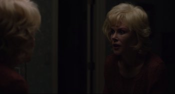 Movie still from “Boy Erased” (2018), directed by Joel Edgerton – A woman in a red sweater is looking at a mirror; Close Up shot, Over the shoulder angle