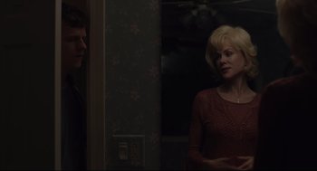 Movie still from “Boy Erased” (2018), directed by Joel Edgerton – A woman standing next to a man near a wall; Medium shot, Over the shoulder angle