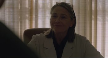 Movie still from “Boy Erased” (2018), directed by Joel Edgerton – A woman sitting in a chair wearing a white lab coat; Close Up shot, Over the shoulder angle