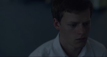 Movie still from “Boy Erased” (2018), directed by Joel Edgerton – A young man in a white dress shirt is looking down; Close Up shot, High angle