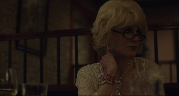 Movie still from “Boy Erased” (2018), directed by Joel Edgerton – A woman with blonde hair wearing glasses and wearing a necklace; Close Up shot, Over the shoulder angle
