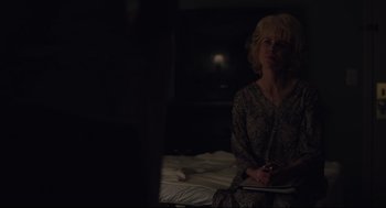 Movie still from “Boy Erased” (2018), directed by Joel Edgerton – A woman sitting on top of a bed in the dark; Medium shot, Over the shoulder angle