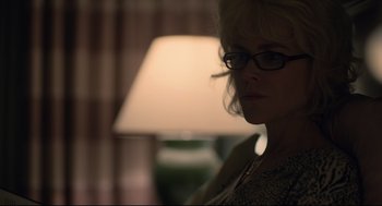 Movie still from “Boy Erased” (2018), directed by Joel Edgerton – A woman wearing glasses standing in front of a lamp; Close Up shot, Over the shoulder angle
