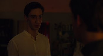 Movie still from “Boy Erased” (2018), directed by Joel Edgerton – A young man standing in a dark room; Close Up shot, Over the shoulder angle