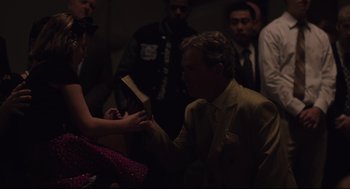 Movie still from “Boy Erased” (2018), directed by Joel Edgerton – A man in a yellow suit is holding a woman's hand; Medium shot, Over the shoulder angle