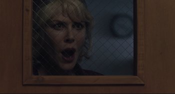 Movie still from “Boy Erased” (2018), directed by Joel Edgerton – A woman with her mouth wide open behind a fence; Close Up shot, Over the shoulder angle