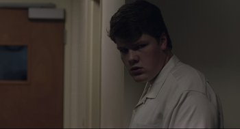 Movie still from “Boy Erased” (2018), directed by Joel Edgerton – A man in a white shirt is standing in a room; Close Up shot, Low angle