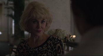Movie still from “Boy Erased” (2018), directed by Joel Edgerton – A woman with blonde hair and a leopard print top; Close Up shot, Over the shoulder angle