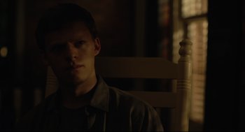 Movie still from “Boy Erased” (2018), directed by Joel Edgerton – A man sitting on a chair in a dark room; Close Up shot, Over the shoulder angle