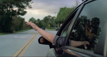 Movie still from “Boy Erased” (2018), directed by Joel Edgerton – A man is leaning out of the window of a car; Medium shot, Low angle