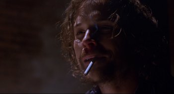Movie still from “Boys Don't Cry” (1999), directed by Kimberly Peirce – A person holding a cigarette in his mouth; Close Up shot, Low angle