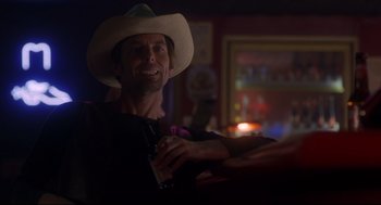 Movie still from “Boys Don't Cry” (1999), directed by Kimberly Peirce – A man in a cowboy hat is holding a beer; Close Up shot, Low angle