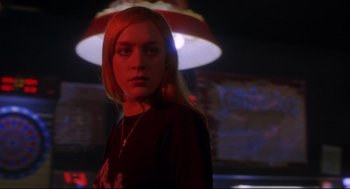 Movie still from “Boys Don't Cry” (1999), directed by Kimberly Peirce – A woman standing in a dark room with a lamp in the background; Close Up shot, Low angle
