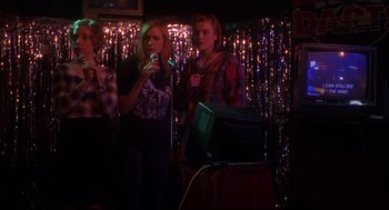 Movie still from “Boys Don't Cry” (1999), directed by Kimberly Peirce – A group of young people singing into microphones; Medium shot, Low angle
