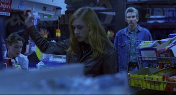 Movie still from “Boys Don't Cry” (1999), directed by Kimberly Peirce – A woman standing next to a man in a room; Medium shot, Over the shoulder angle