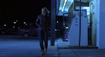 Movie still from “Boys Don't Cry” (1999), directed by Kimberly Peirce – A woman walking down the sidewalk at night; Wide shot, Low angle