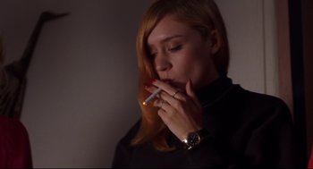 Movie still from “Boys Don't Cry” (1999), directed by Kimberly Peirce – A woman is smoking a cigarette in a dark room; Close Up shot, Low angle