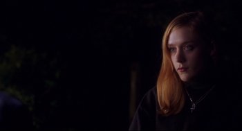 Movie still from “Boys Don't Cry” (1999), directed by Kimberly Peirce – A woman with long red hair standing in the dark; Close Up shot, Over the shoulder angle