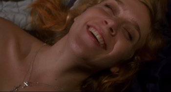 Movie still from “Boys Don't Cry” (1999), directed by Kimberly Peirce – A person smiling with their eyes closed; Extreme Close Up shot, Overhead angle