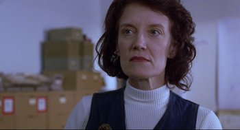 Movie still from “Boys Don't Cry” (1999), directed by Kimberly Peirce – An older woman wearing a white shirt and a blue vest; Close Up shot, Low angle