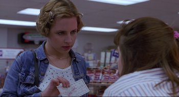 Movie still from “Boys Don't Cry” (1999), directed by Kimberly Peirce – A woman is holding a ticket in her hand; Close Up shot, Over the shoulder angle