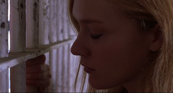 Movie still from “Boys Don't Cry” (1999), directed by Kimberly Peirce – A woman with her eyes closed holding a cell phone; Close Up shot, Low angle