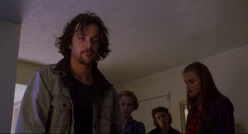 Movie still from “Boys Don't Cry” (1999), directed by Kimberly Peirce – A group of people standing in a living room; Medium shot, Low angle