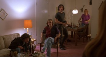 Movie still from “Boys Don't Cry” (1999), directed by Kimberly Peirce – A group of people sitting in a living room; Wide shot, Low angle