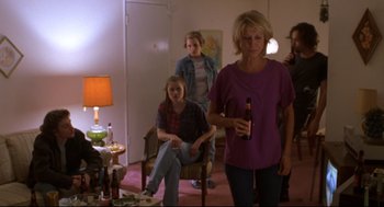 Movie still from “Boys Don't Cry” (1999), directed by Kimberly Peirce – A group of people standing in a living room; Wide shot, High angle
