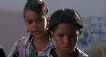Movie still from “Boyz n the Hood” (1991), directed by John Singleton – A young boy and a young girl standing next to each other; Close Up shot, Low angle