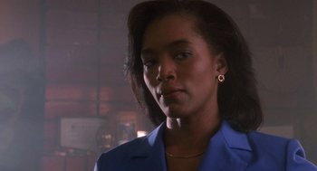 Movie still from “Boyz n the Hood” (1991), directed by John Singleton – A woman in a blue jacket is looking at the camera; Close Up shot, Low angle