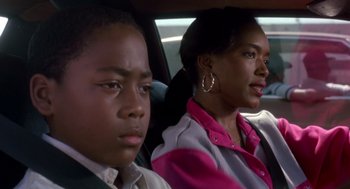 Movie still from “Boyz n the Hood” (1991), directed by John Singleton – A woman sitting next to a boy in the back of a car; Close Up shot, Over the shoulder angle