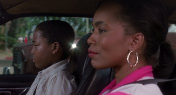 Movie still from “Boyz n the Hood” (1991), directed by John Singleton – A woman sitting next to a man in a car; Close Up shot, Over the shoulder angle