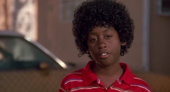 Movie still from “Boyz n the Hood” (1991), directed by John Singleton – A young man with a black afro is looking at the camera; Close Up shot, Low angle