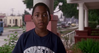 Movie still from “Boyz n the Hood” (1991), directed by John Singleton – A young boy standing in front of a building; Close Up shot, Low angle