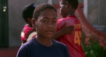 Movie still from “Boyz n the Hood” (1991), directed by John Singleton – A young boy is standing in front of other young boys; Close Up shot, Low angle