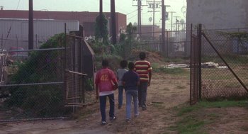 Movie still from “Boyz n the Hood” (1991), directed by John Singleton – A group of young people walking down a dirt road; Extreme Wide shot, High angle