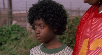 Movie still from “Boyz n the Hood” (1991), directed by John Singleton – A young boy with a black afro is looking to his left; Close Up shot, Low angle