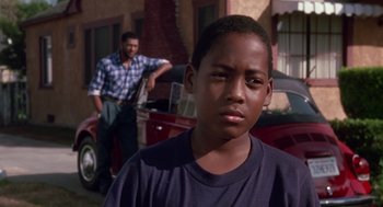 Movie still from “Boyz n the Hood” (1991), directed by John Singleton – A young boy standing in front of an older man; Close Up shot, Low angle
