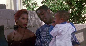 Movie still from “Boyz n the Hood” (1991), directed by John Singleton – A man and a woman and a baby in front of a building; Close Up shot, Over the shoulder angle