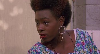 Movie still from “Boyz n the Hood” (1991), directed by John Singleton – A person wearing a floral shirt; Close Up shot, Over the shoulder angle