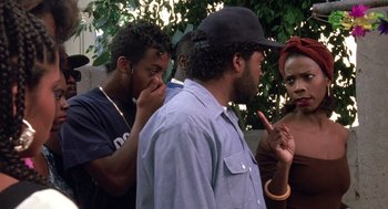 Movie still from “Boyz n the Hood” (1991), directed by John Singleton – A group of men and women standing next to each other; Medium shot, Over the shoulder angle