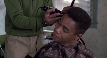 Movie still from “Boyz n the Hood” (1991), directed by John Singleton – A man getting his hair cut by a barber; Close Up shot, Over the shoulder angle