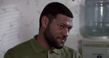 Movie still from “Boyz n the Hood” (1991), directed by John Singleton – A person wearing a green shirt; Close Up shot, High angle