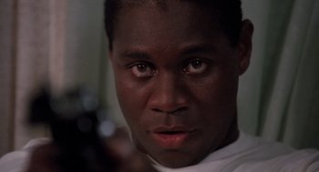 Movie still from “Boyz n the Hood” (1991), directed by John Singleton – A person with a gun; Close Up shot, Low angle