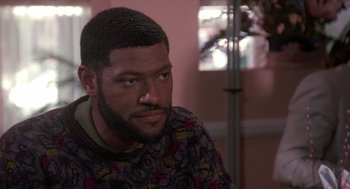 Movie still from “Boyz n the Hood” (1991), directed by John Singleton – A person sitting in front of a window; Close Up shot, Over the shoulder angle