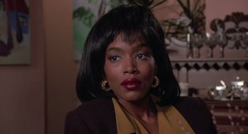 Movie still from “Boyz n the Hood” (1991), directed by John Singleton – A black woman with long black hair wearing a brown jacket; Close Up shot, Over the shoulder angle
